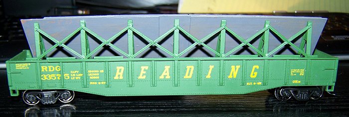 A photo of the completed GHm plate steel gondola hauling a modeled load.