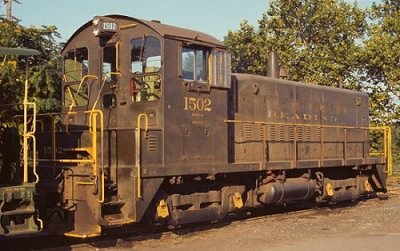 Reading SW900 #1502 coupled to a yellow-and-green caboose at Pottsville.  Photo courtesy Kim Piersol.